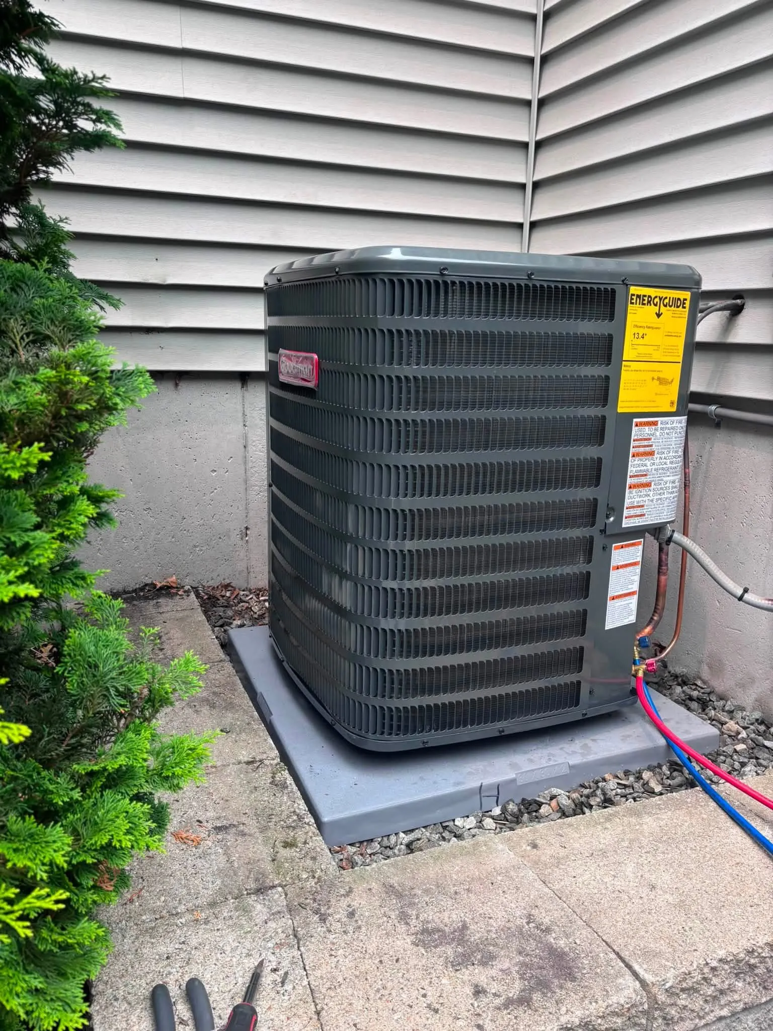 Refrigerant gauges connected to a Goodman condenser during service