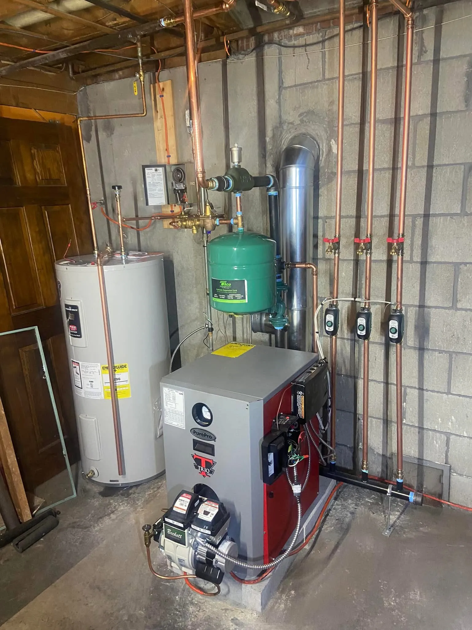 PurePro oil boiler with three purge stations beside a water heater