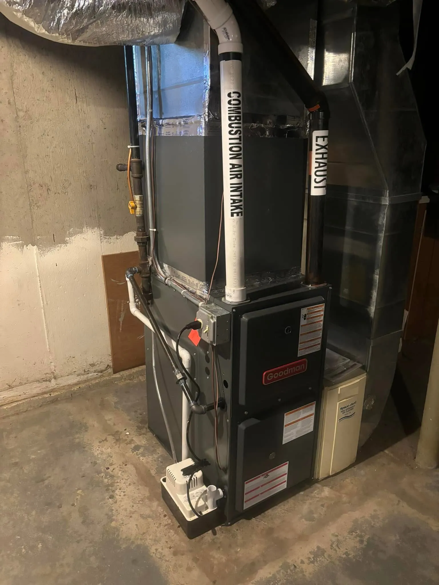 Goodman gas furnace with labeled combustion air intake and exhaust runs