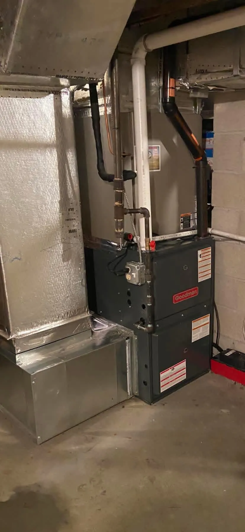 A Goodman gas furnace with a new insulated plenum and ductwork, installed by Hannon