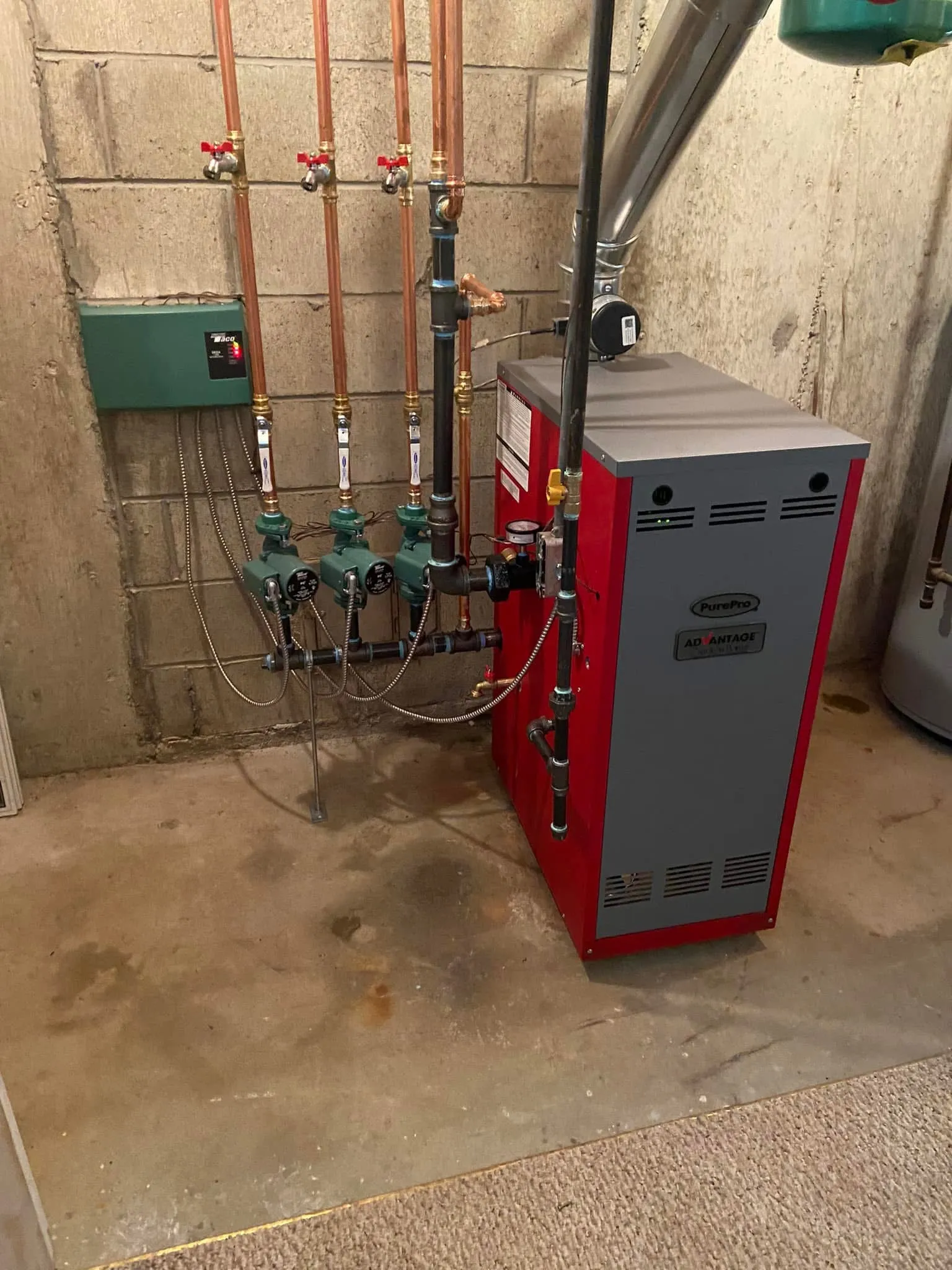 Red PurePro gas boiler with Taco zone controls and three circulator pumps