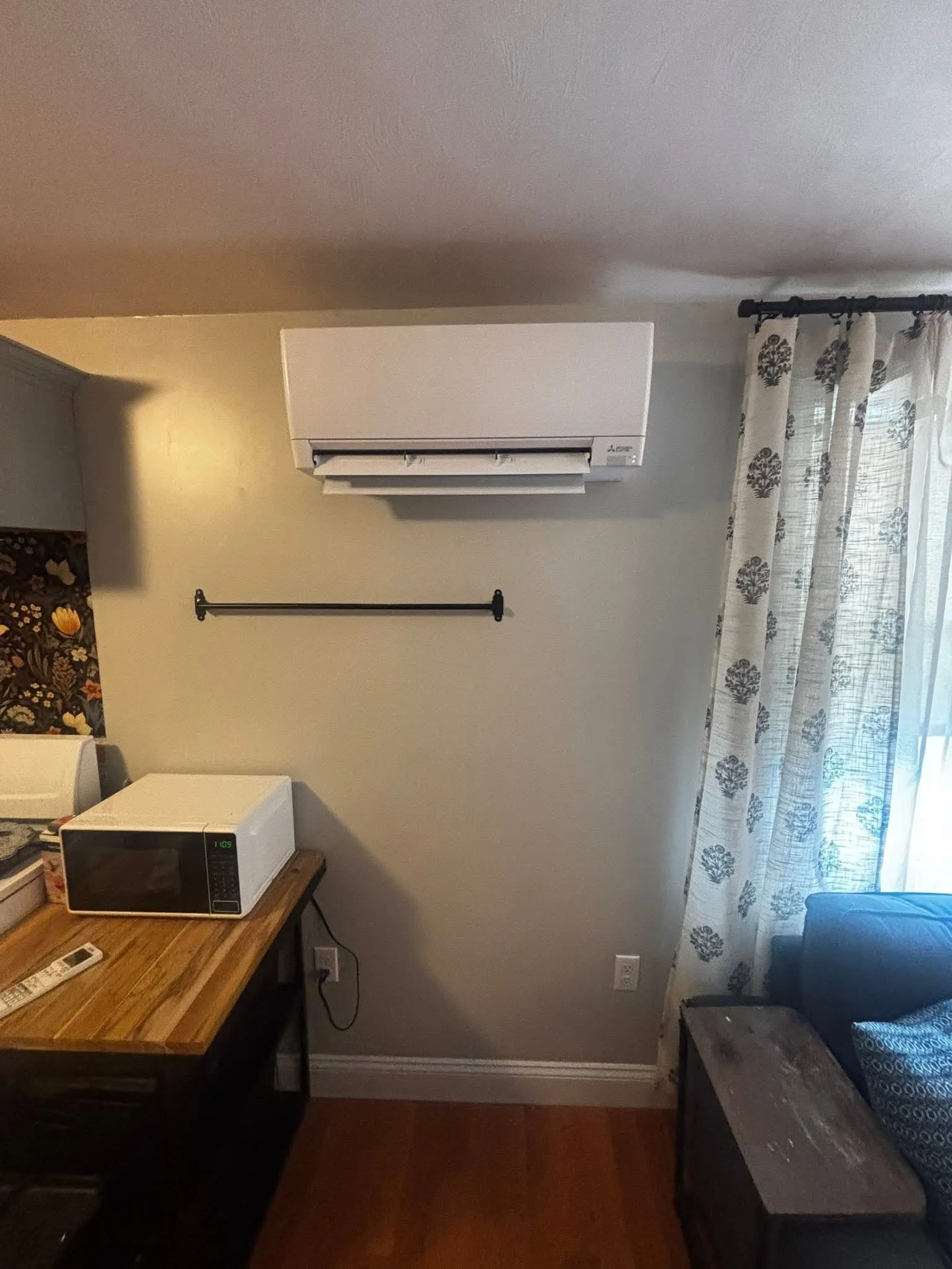 Mitsubishi wall-mounted mini-split indoor unit in a finished living room