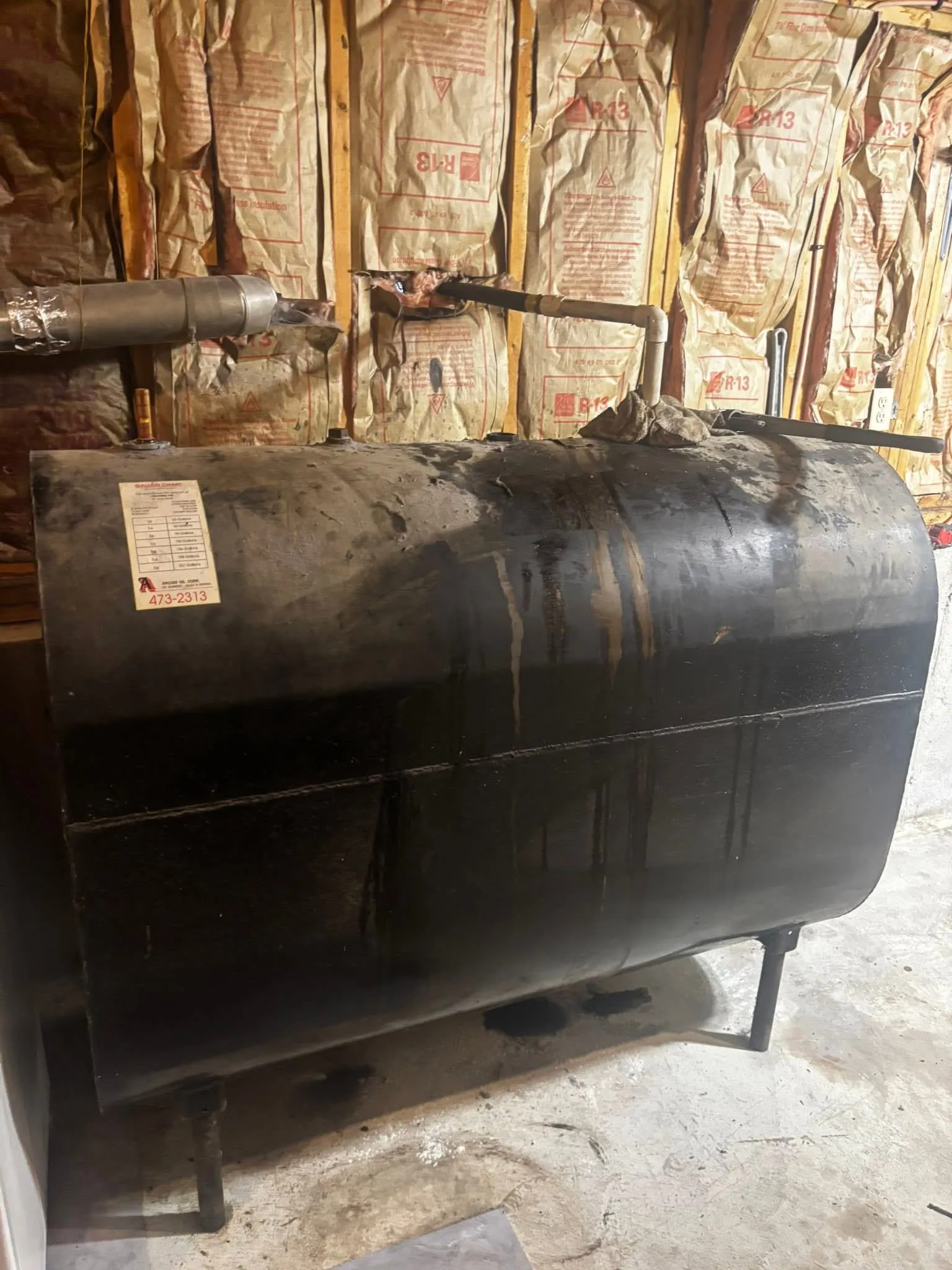 Old single-wall steel oil tank before replacement