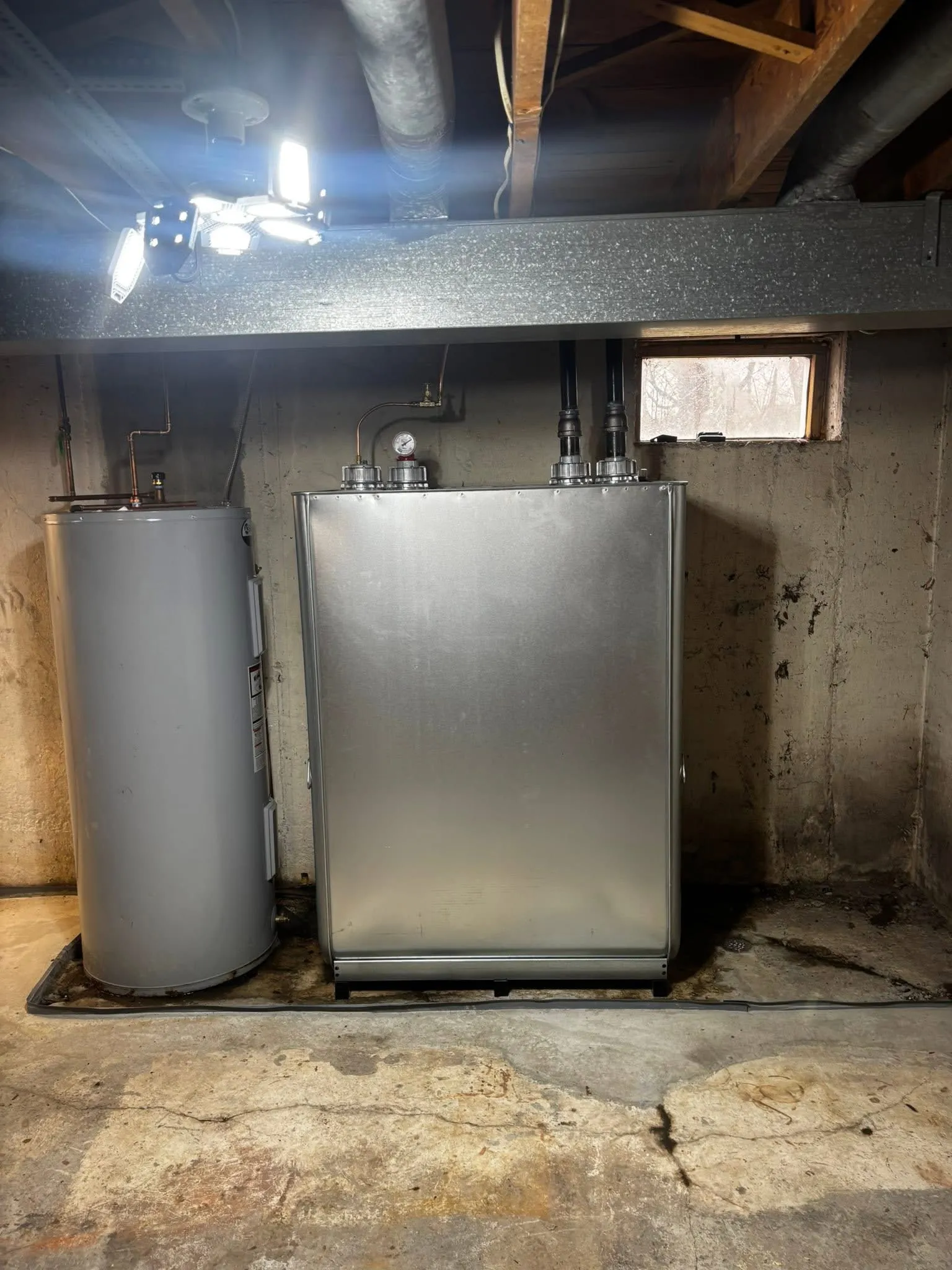 New vertical double-wall oil tank installed by Hannon beside an electric water heater