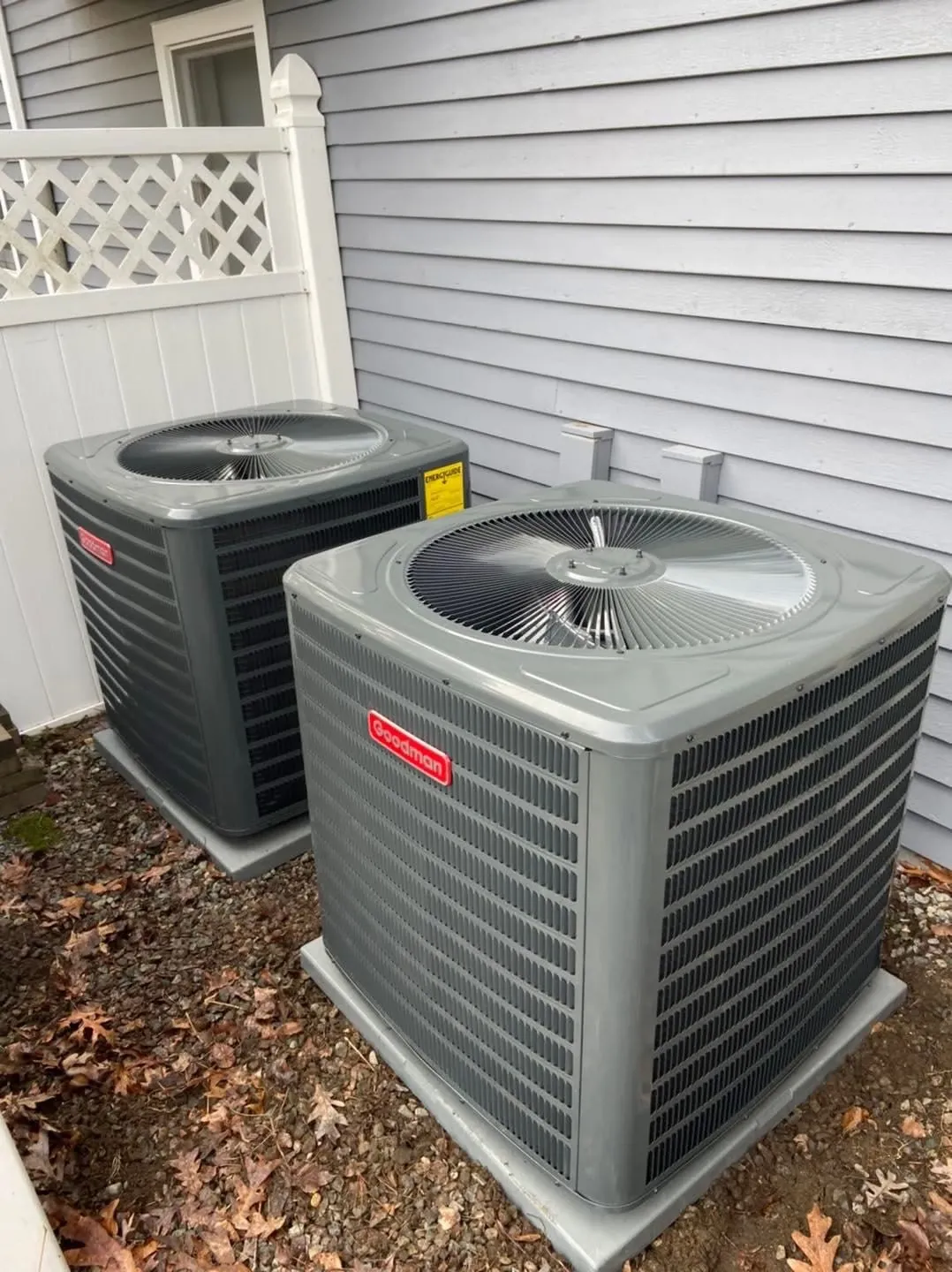 Central air conditioning unit beside a New England home