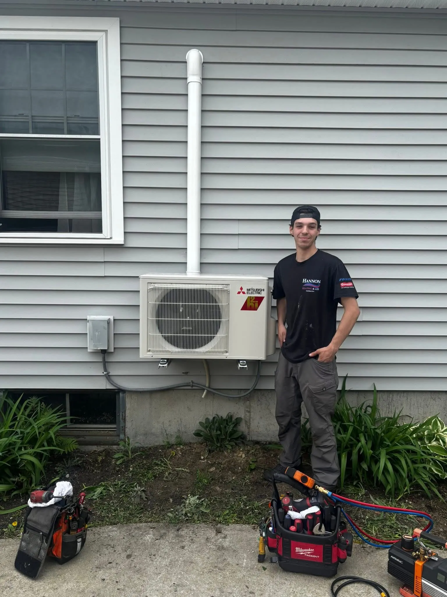 Hannon technician installing a Mitsubishi ductless mini-split outdoor unit